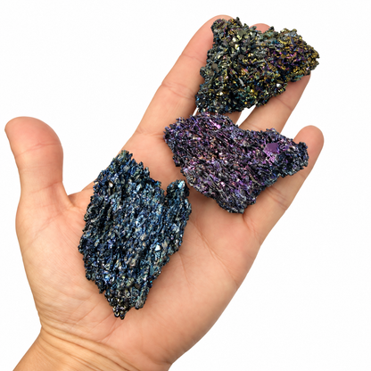 Raw rainbow Carborundum specimen with gold, blue, and purple crystal faces held in hand