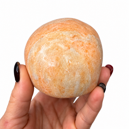 Peach calcite crystal skull side view with creamy white and peach coloring - Magick Souls