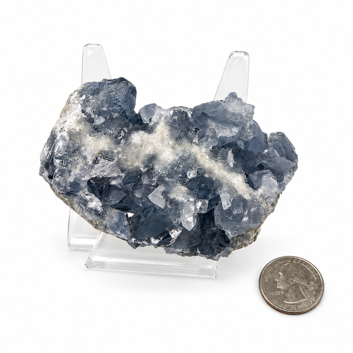 Celestite crystal cluster beside a quarter for size reference