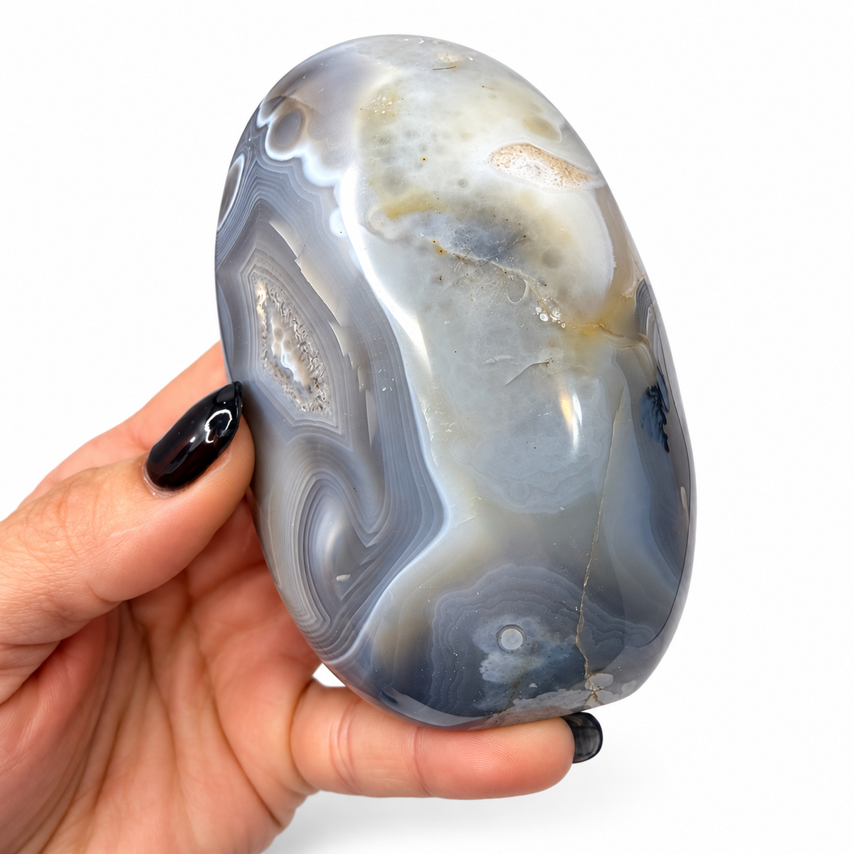 Polished banded agate freeform in gray and blue, next to a quarter for scale - Magick Souls