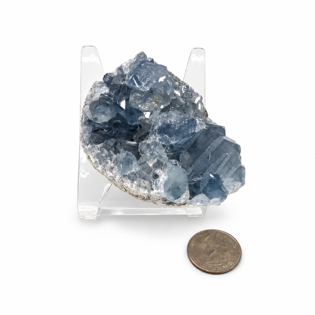Blue Celestite cluster next to a quarter for size