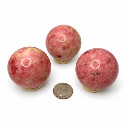 Polished pink zoisite sphere with cream and green flecks - Magick Souls