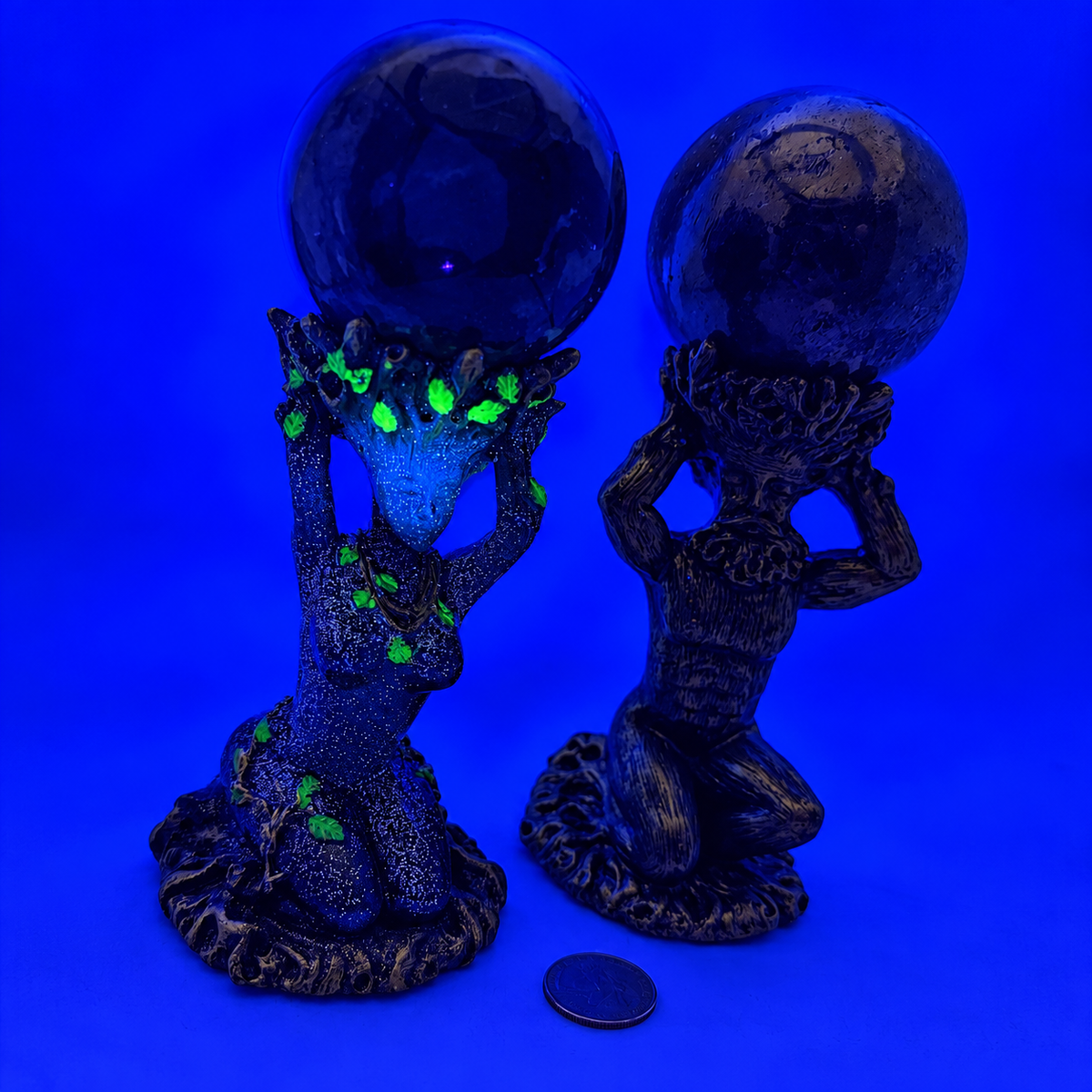 God and Goddess sphere stands under UV blacklight, Goddess stand's green leaf accents glowing bright green