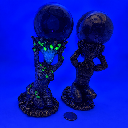God and Goddess sphere stands under UV blacklight, Goddess stand's green leaf accents glowing bright green