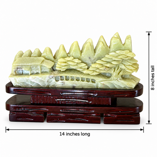 Hand-carved Xiuyan jade mountain village landscape sculpture on carved wood stand, 14 inches long by 8 inches tall