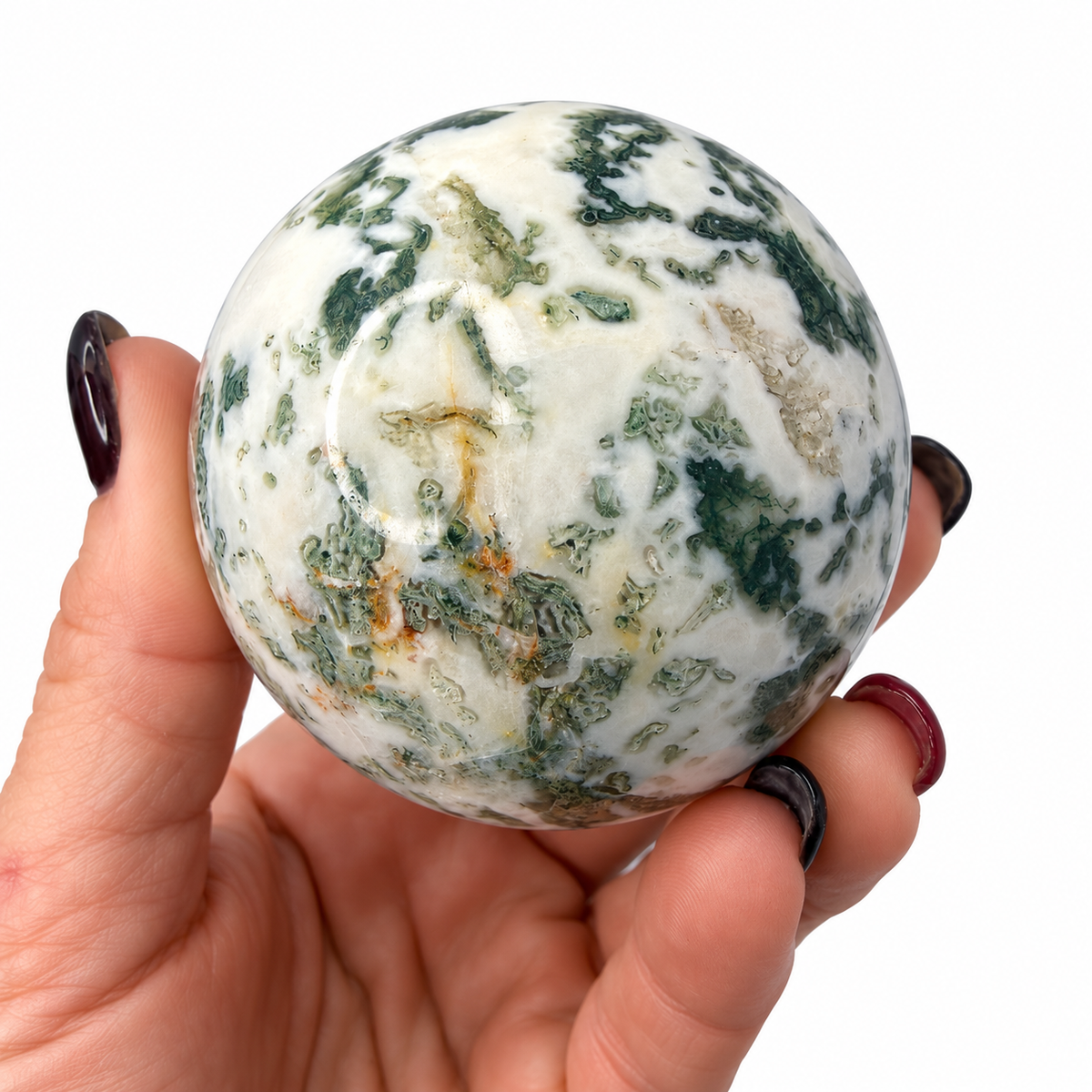50mm green moss agate sphere in hand for scale - Magick Souls