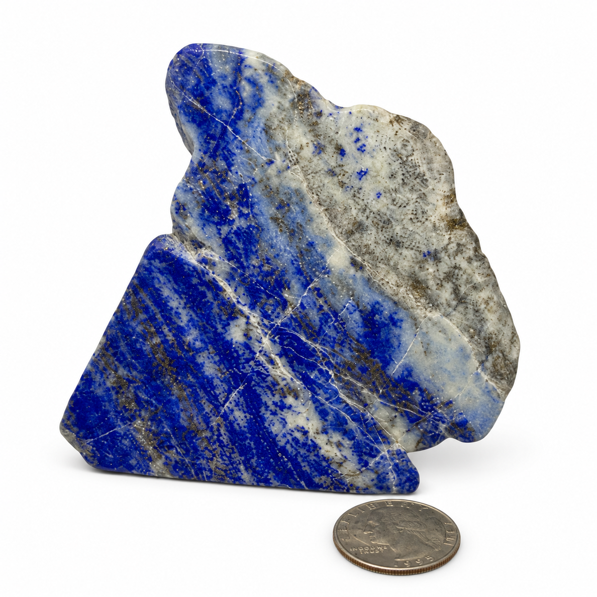 Polished lapis lazuli slab in royal blue with pyrite flecks, next to a quarter for scale - Magick Souls