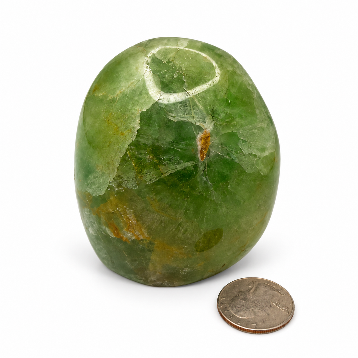 UV reactive green fluorite freeform, polished standing crystal next to a quarter for scale - Magick Souls