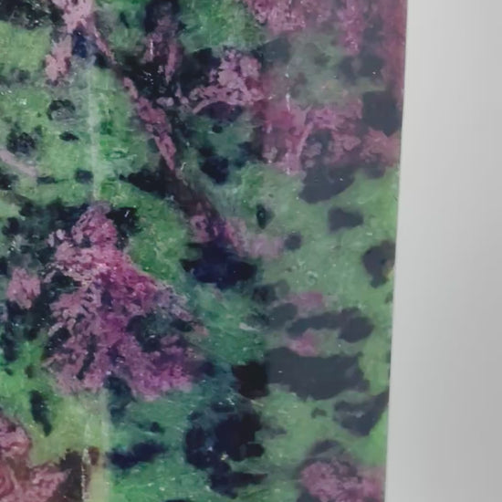 Video of Ruby Zoisite tower glowing red under UV blacklight