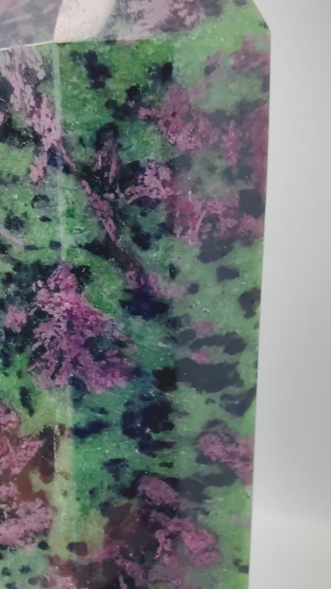 Video of Ruby Zoisite tower glowing red under UV blacklight