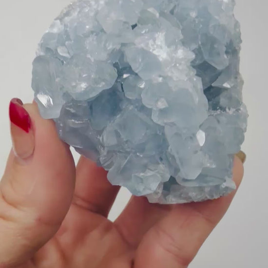 Video of a Celestite crystal cluster glittering in the light