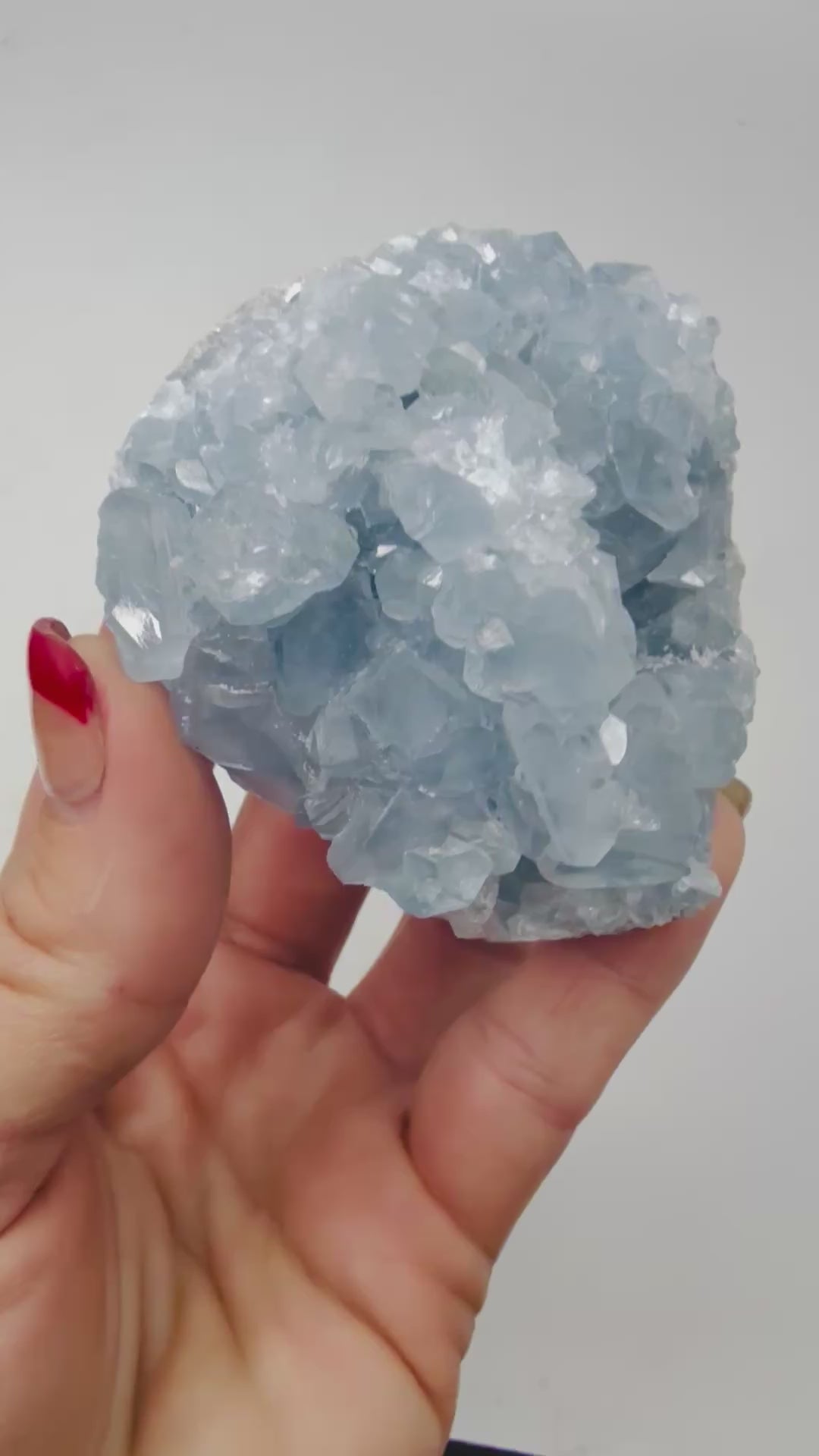 Video of a Celestite crystal cluster glittering in the light